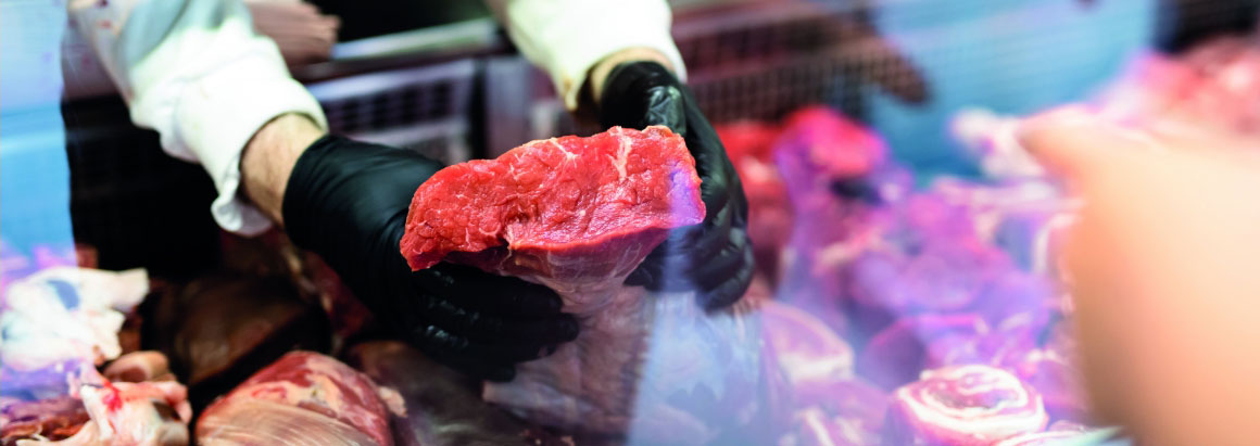 Butcher holding meat