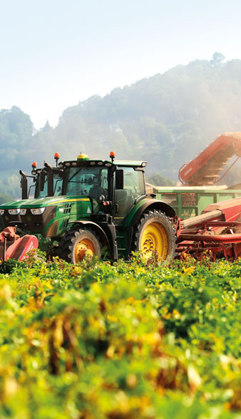 Tractors ploughin potatoes
