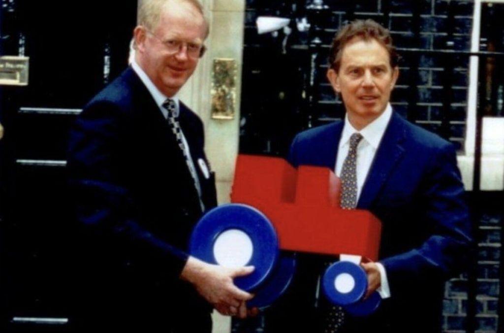 Tony blair holding a red tractor