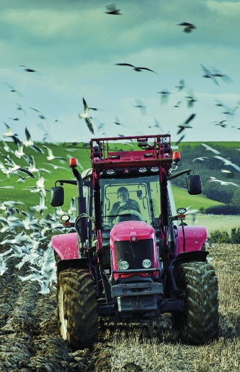 Red Tractor ploughing a field