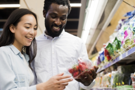 Couple in a shop looking at strawberries